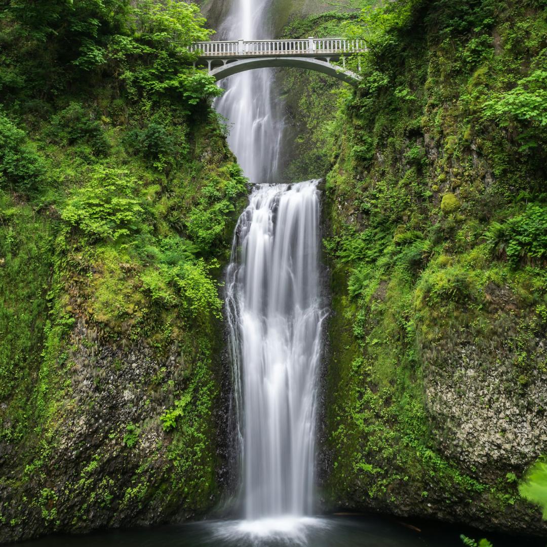 Bridge over a green waterfall